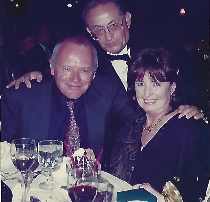 Nate Waxman in a tuxedo with Anthony Hopkins and Margaret O'Brien at a dinner table